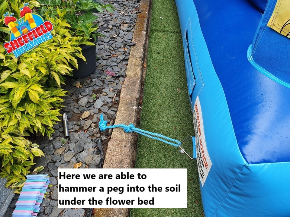 Attaching a bouncy castle on artificial grass