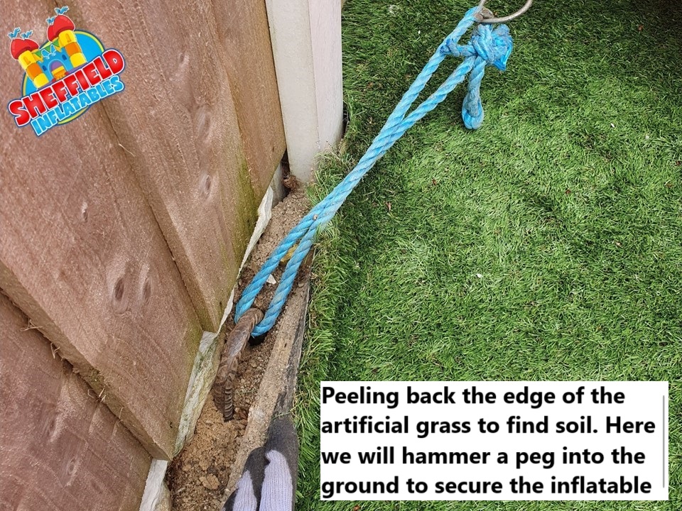 Securing a bouncy castle on artificial grass